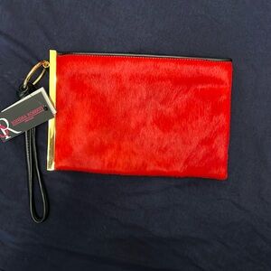 Pony hair clutch with gold trim from Sondra Roberts.
Never worn. Tags Attached.